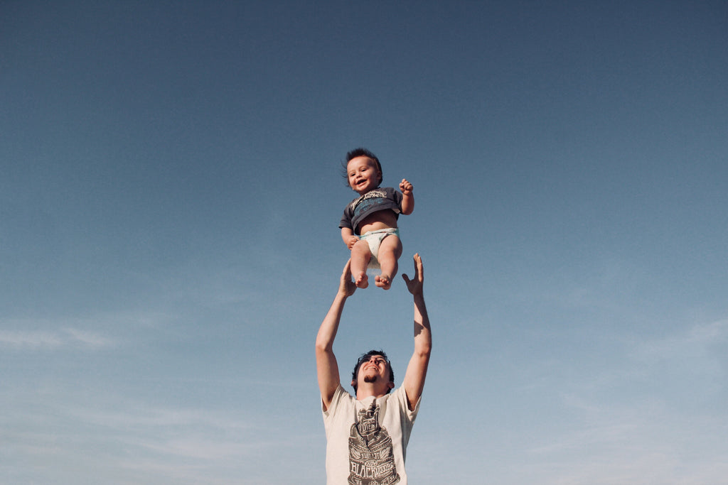 father playing with their kid - event clothing